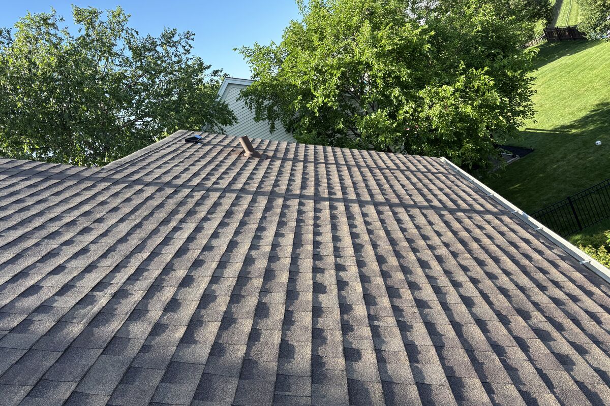 Finished architectural asphalt shingle roof, clean ridge line and new ridge cap