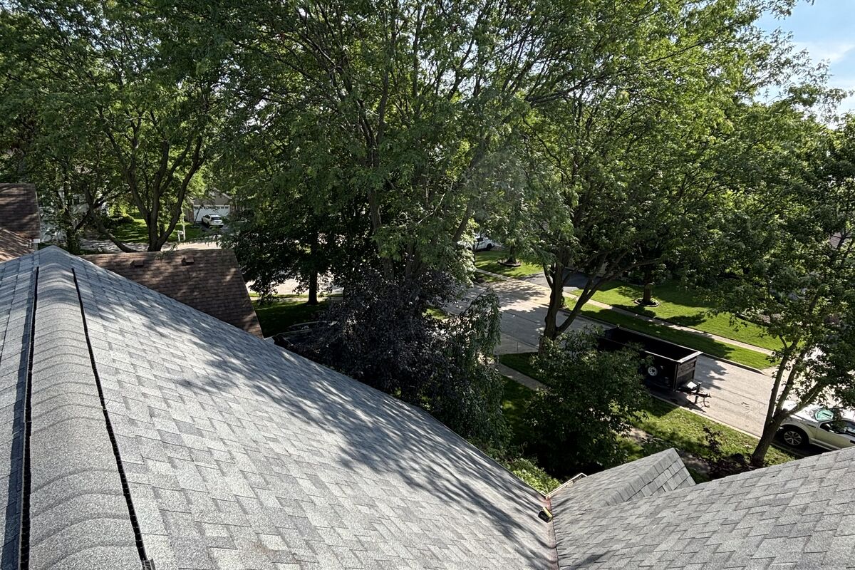 Aged and weathered three-tab shingle roof with granule loss before replacement