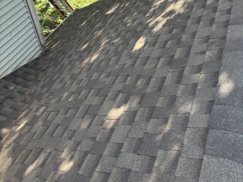Roof valley meeting vinyl siding at the eave on a two-story home